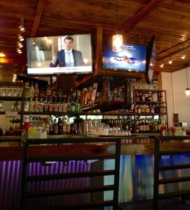 full service bar adorned with metal works and wood shop accents